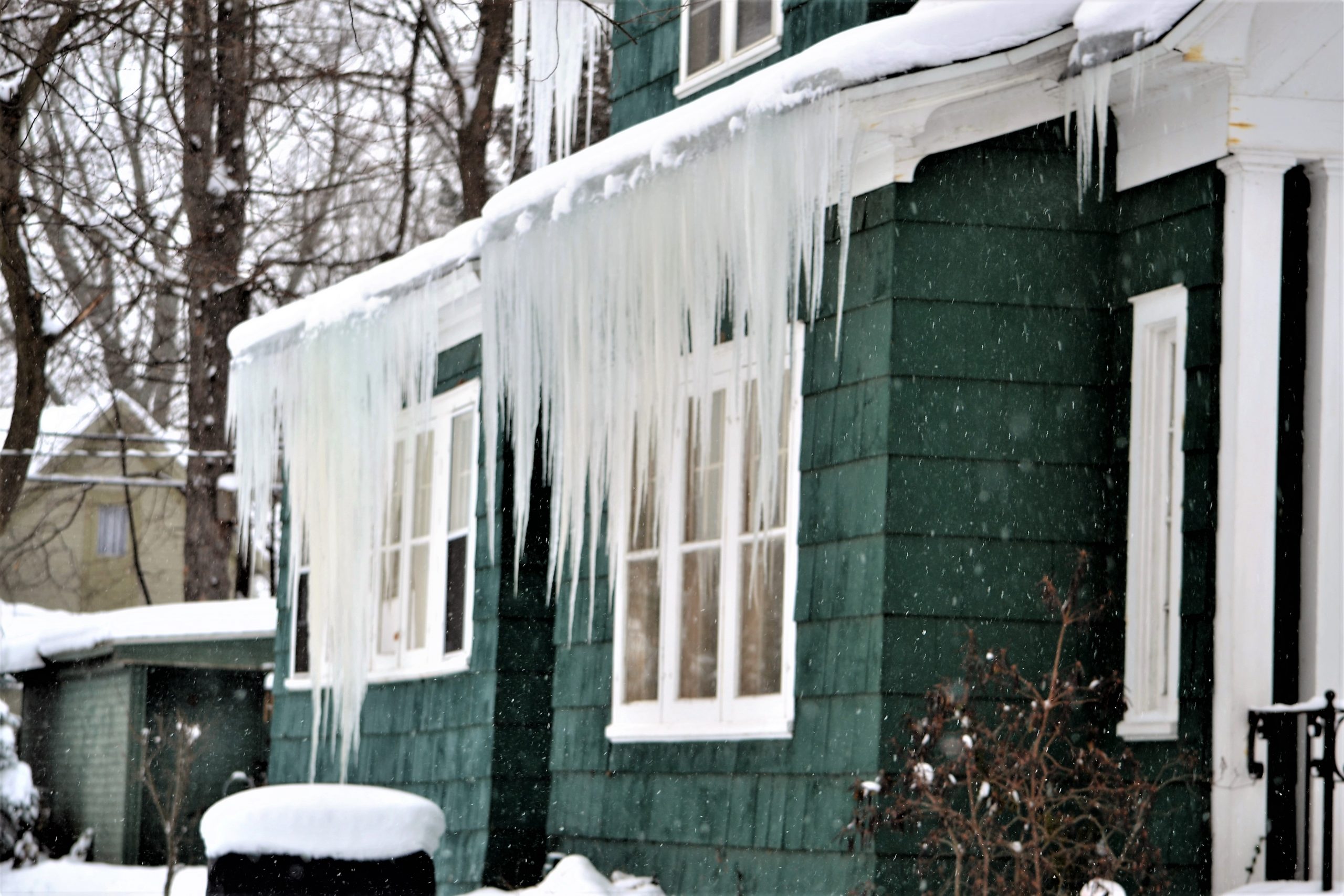 Ice dams and icicles on a roof edge (ice damming example)